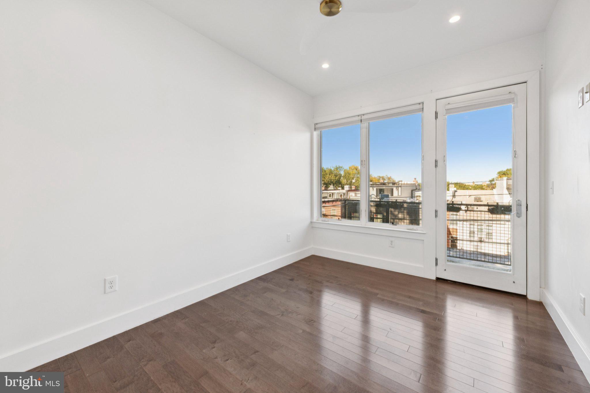 1767 Lanier Place Northwest, Unit 6 Washington, DC 20009 - Photo 39 of 49 an empty room with wooden floor and windows
