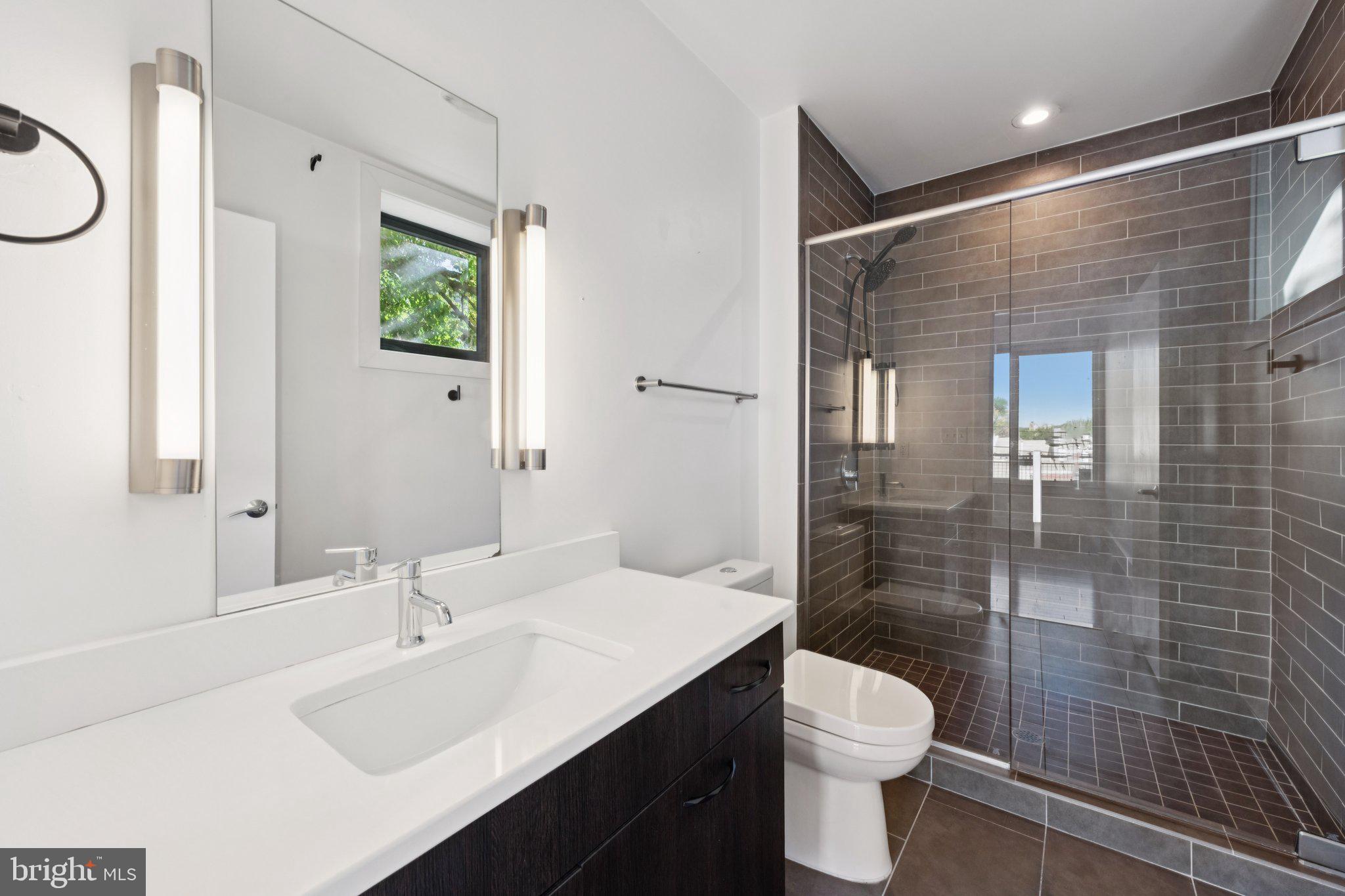 1767 Lanier Place Northwest, Unit 6 Washington, DC 20009 - Photo 41 of 49 a bathroom with a sink a toilet and shower