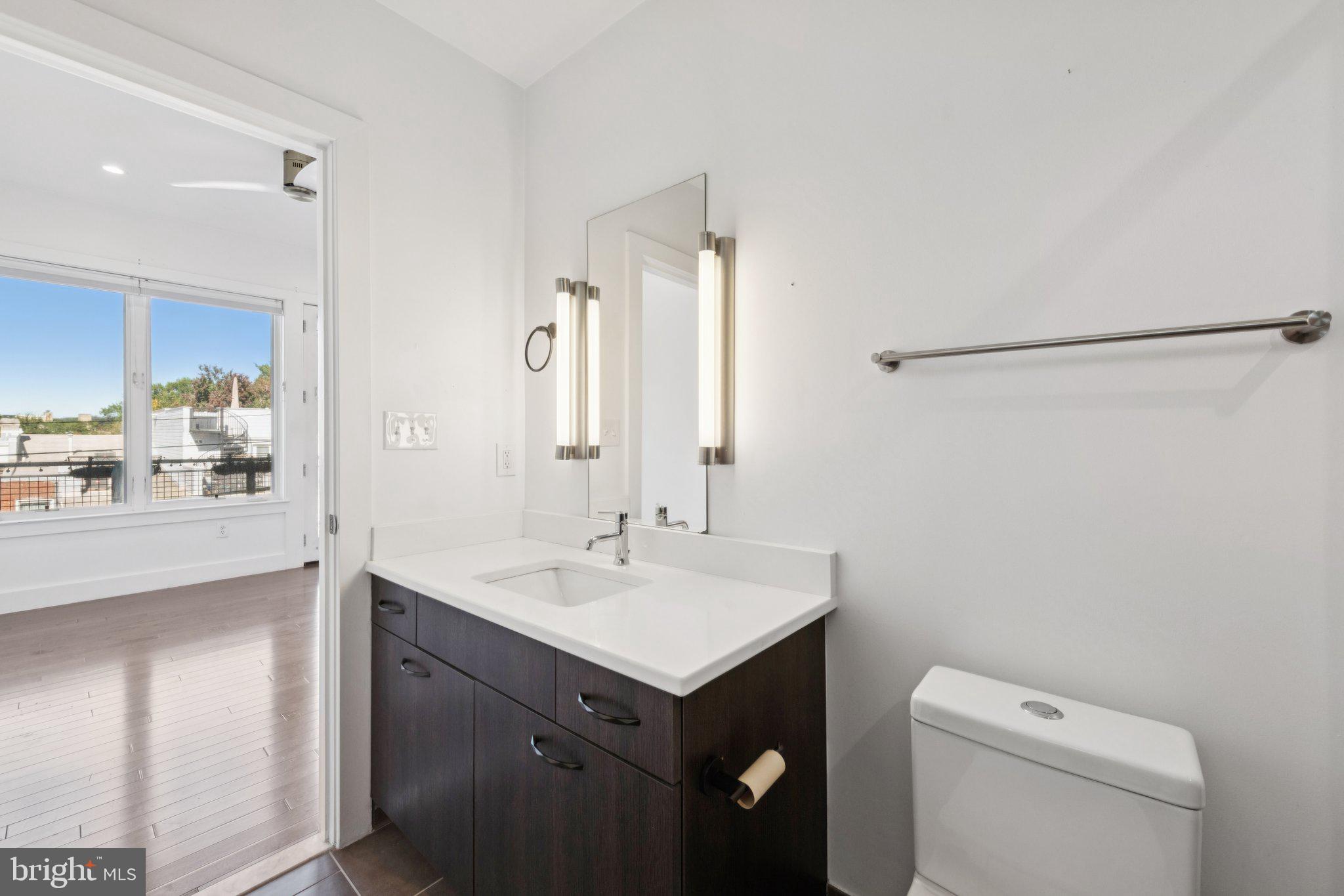 1767 Lanier Place Northwest, Unit 6 Washington, DC 20009 - Photo 42 of 49 a bathroom with a sink toilet and mirror