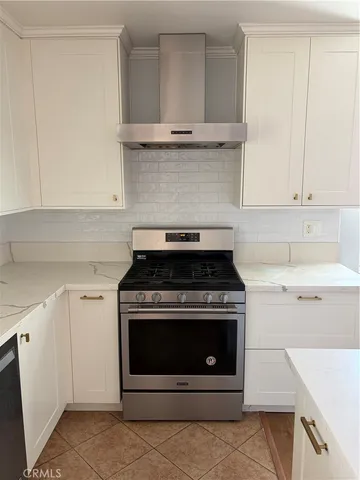 a stove top oven sitting inside of a kitchen