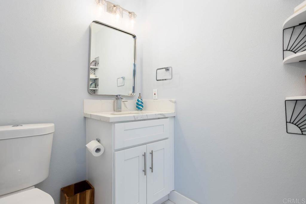 8420 Fanita Drive, Unit 3 Santee, CA 92071 - Photo 11 of 21 a bathroom with a sink mirror vanity and toilet