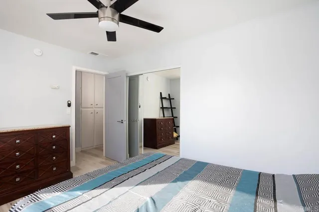 a bedroom with a bed and a dresser