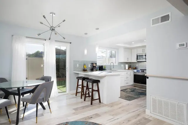 a kitchen with a table and chairs in it