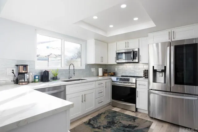 a kitchen with a sink stove and refrigerator