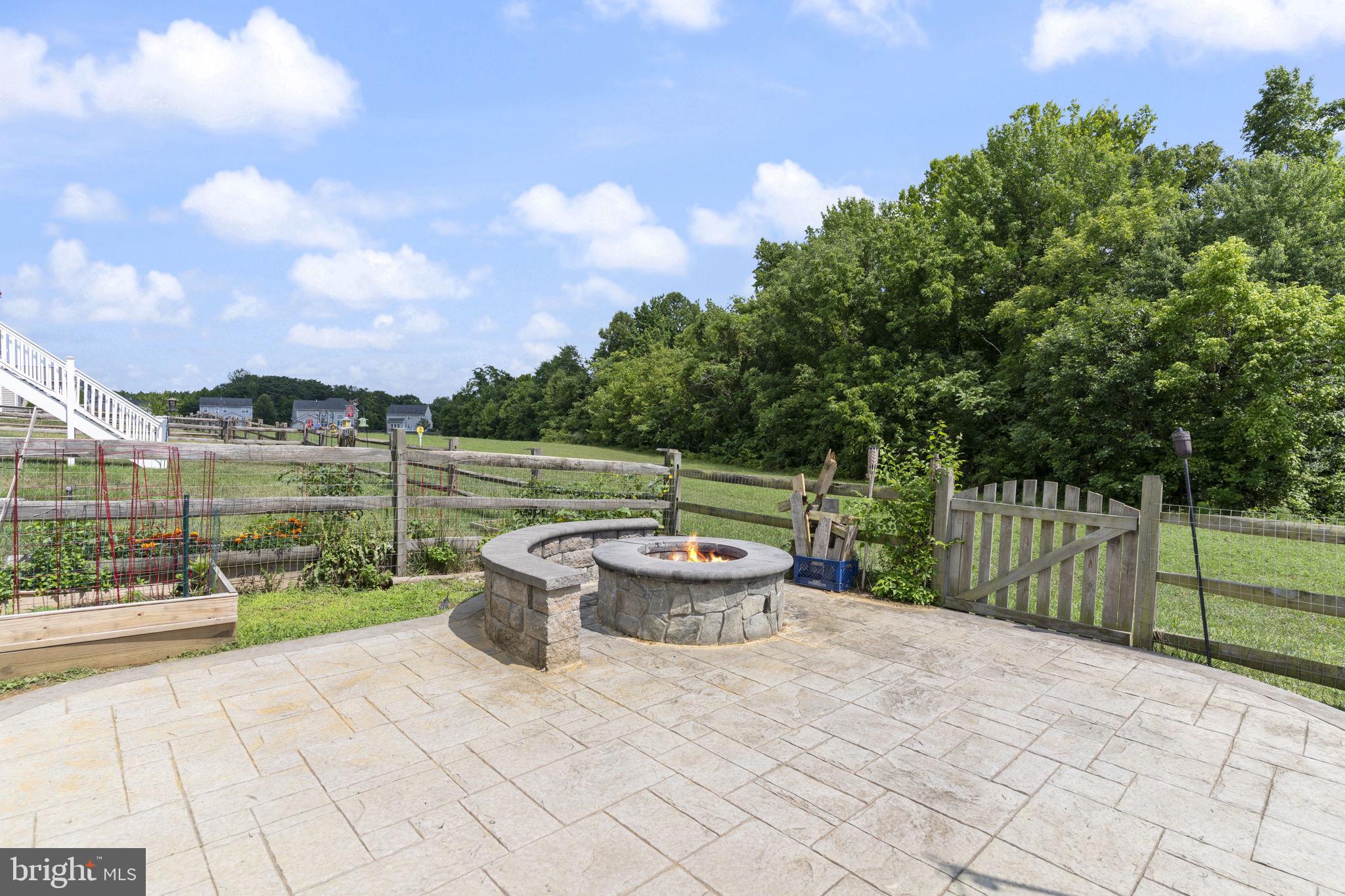 5270 Longbow Road King George, VA 22485 - Photo 58 of 75 Stamped concrete patio with paver fire-pit