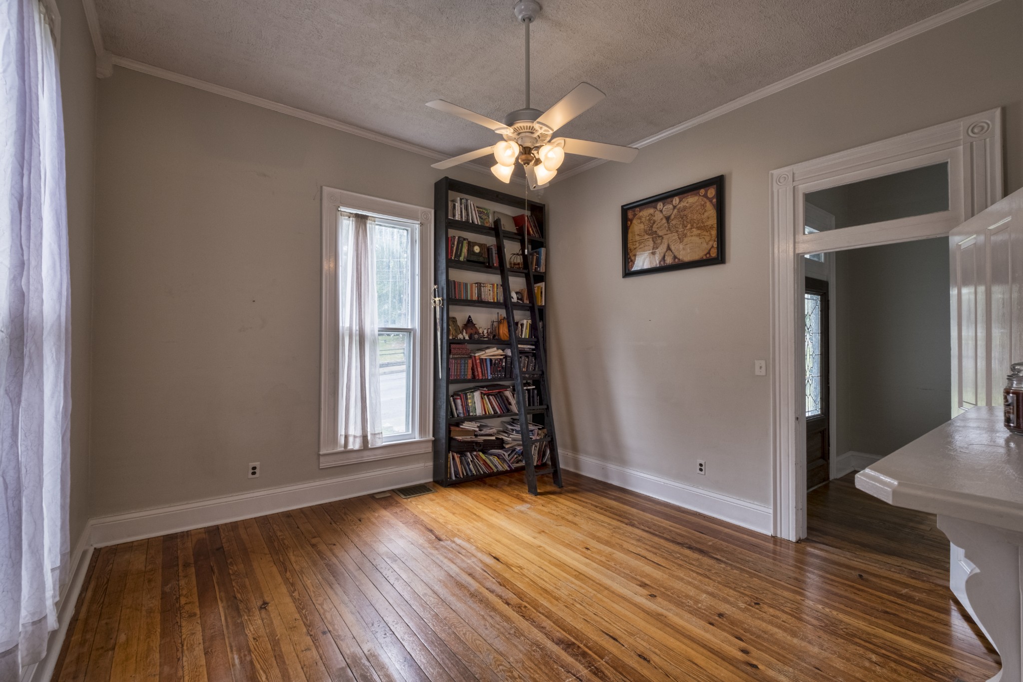 211 North Main Street Springfield, TN 37172 - Photo 11 of 30 an empty room with wooden floor chandelier and windows