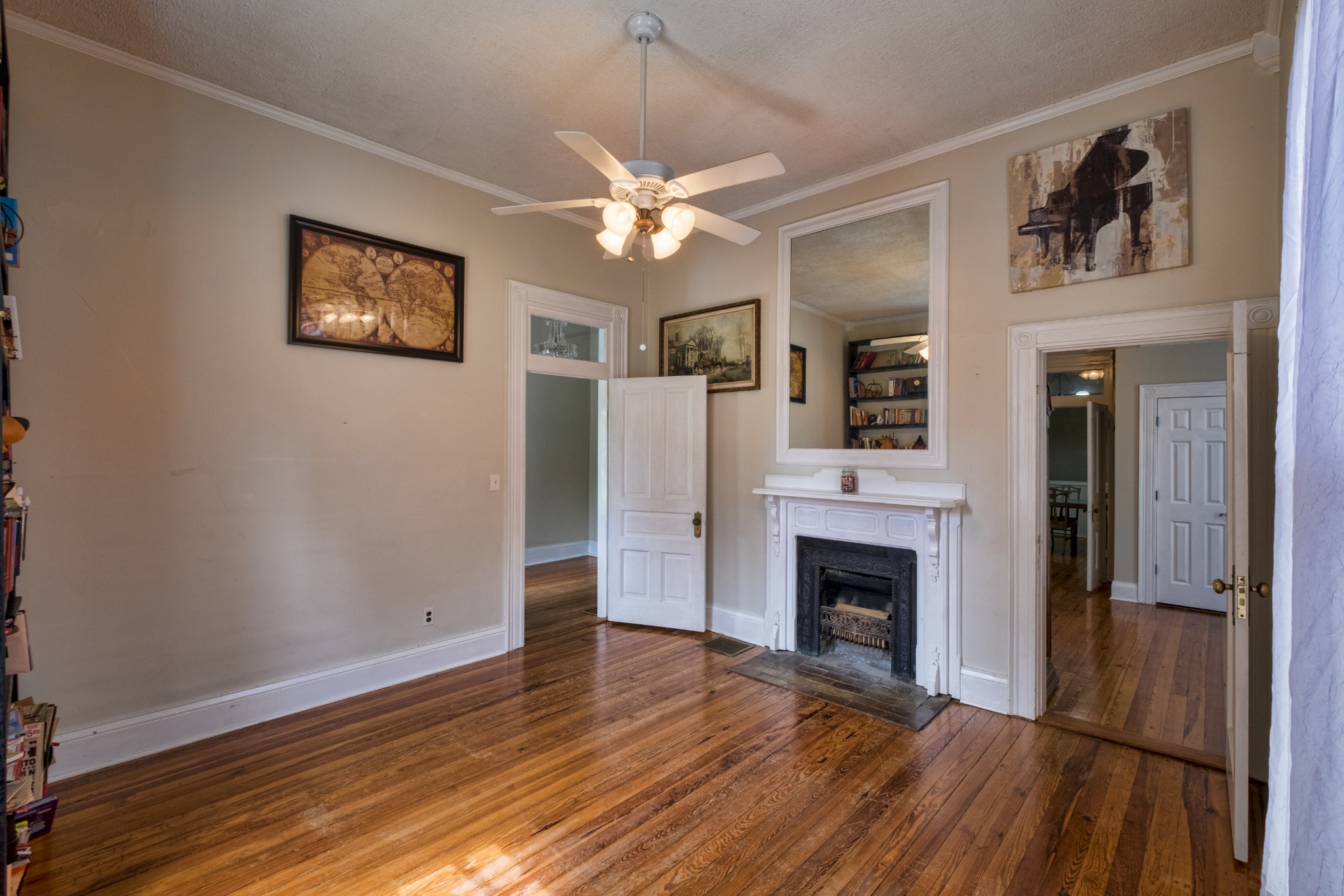 211 North Main Street Springfield, TN 37172 - Photo 10 of 30 a view of a livingroom with a fireplace wooden floor and a ceiling fan