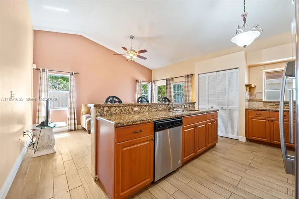 a kitchen with stainless steel appliances granite countertop a stove and cabinets