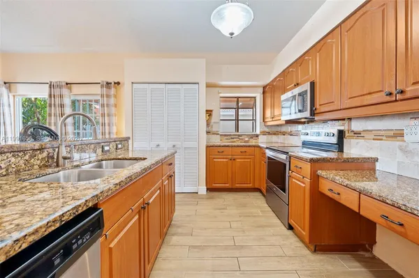 a kitchen with a sink stove and cabinets