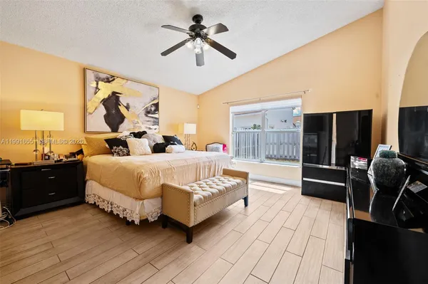 a bed room with a bed and a chandelier