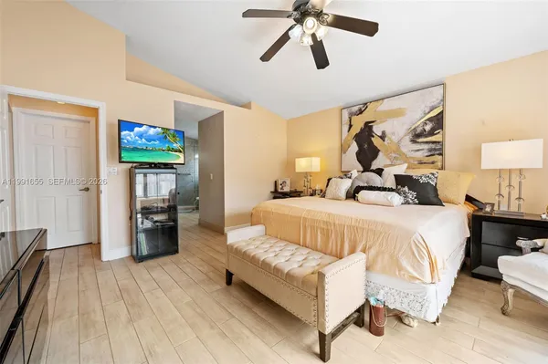 a bedroom with a bed and a chandelier