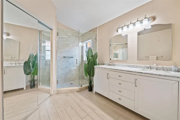 a bathroom with a double vanity sink and a mirror
