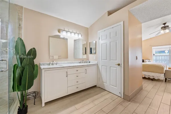 a spacious bathroom with a double vanity sink and a mirror