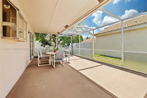 a view of a chairs and table in the patio