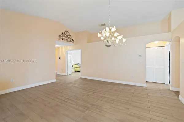 a view of livingroom with chandelier and wooden floor
