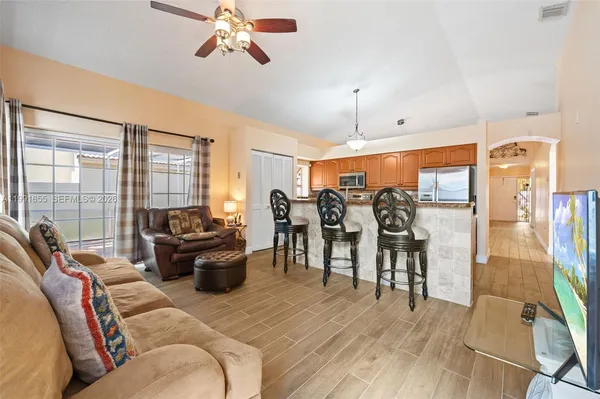 a living room with furniture and wooden floor