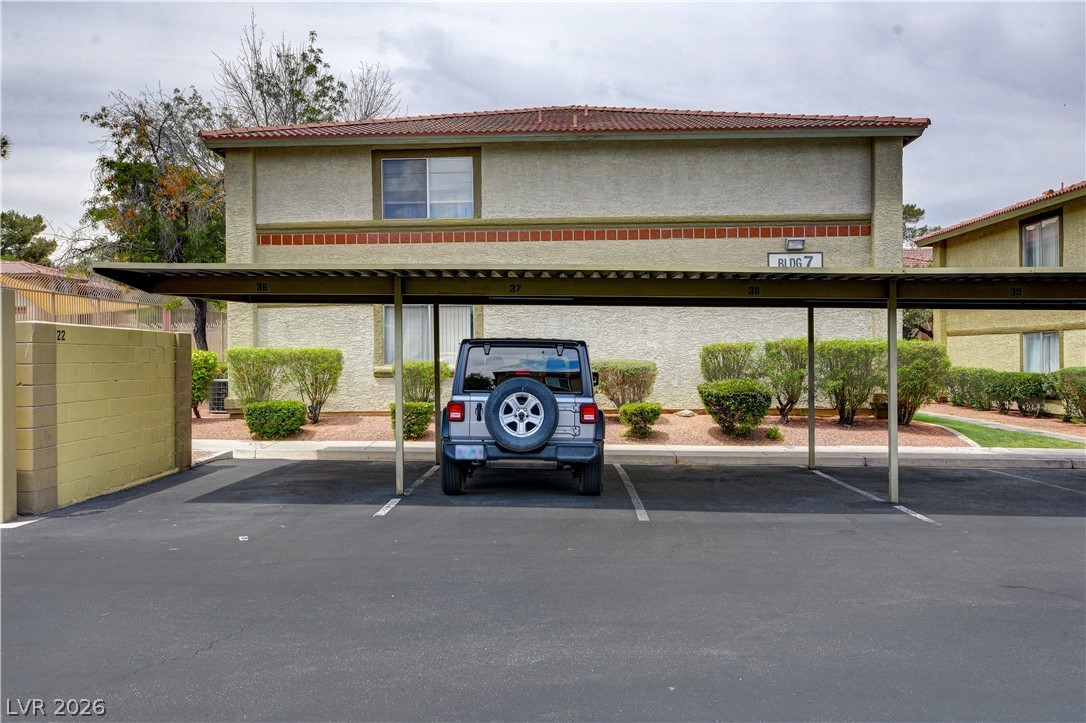 7200 West Pirates Cove Road, Unit 1026 Las Vegas, NV 89145 - Photo 29 of 35 This residential building offers convenient covered parking, enhancing daily living.