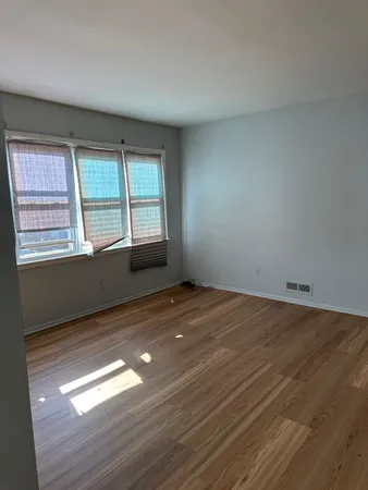 a view of an empty room and wooden floor