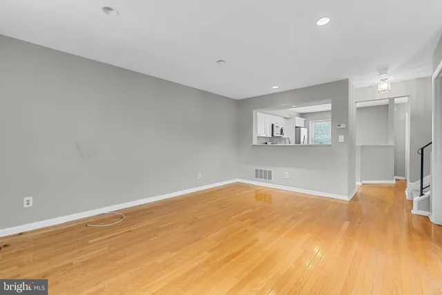 a view of empty room with wooden floor