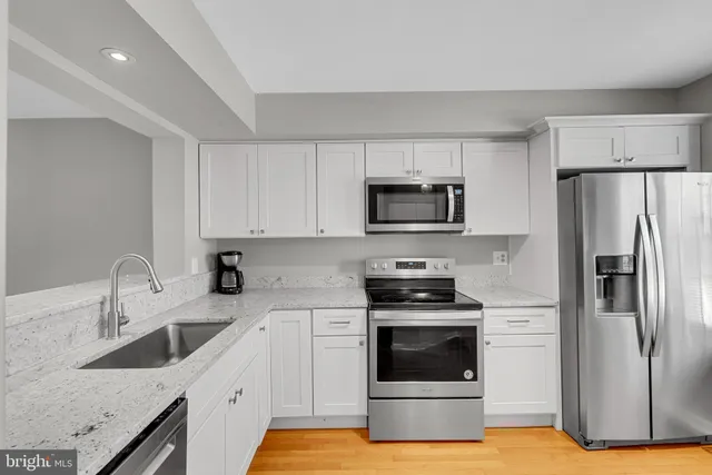 a kitchen with a sink stove and refrigerator