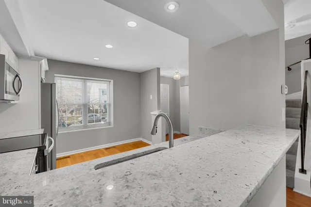 a view of a kitchen with a sink and cabinets