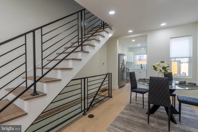 a view of entryway dining room and hall with wooden floor