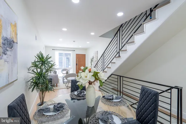 a living room with furniture potted plant and a rug