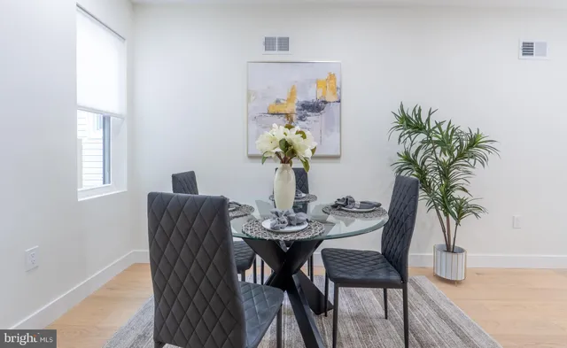 a dining room with furniture and wooden floor