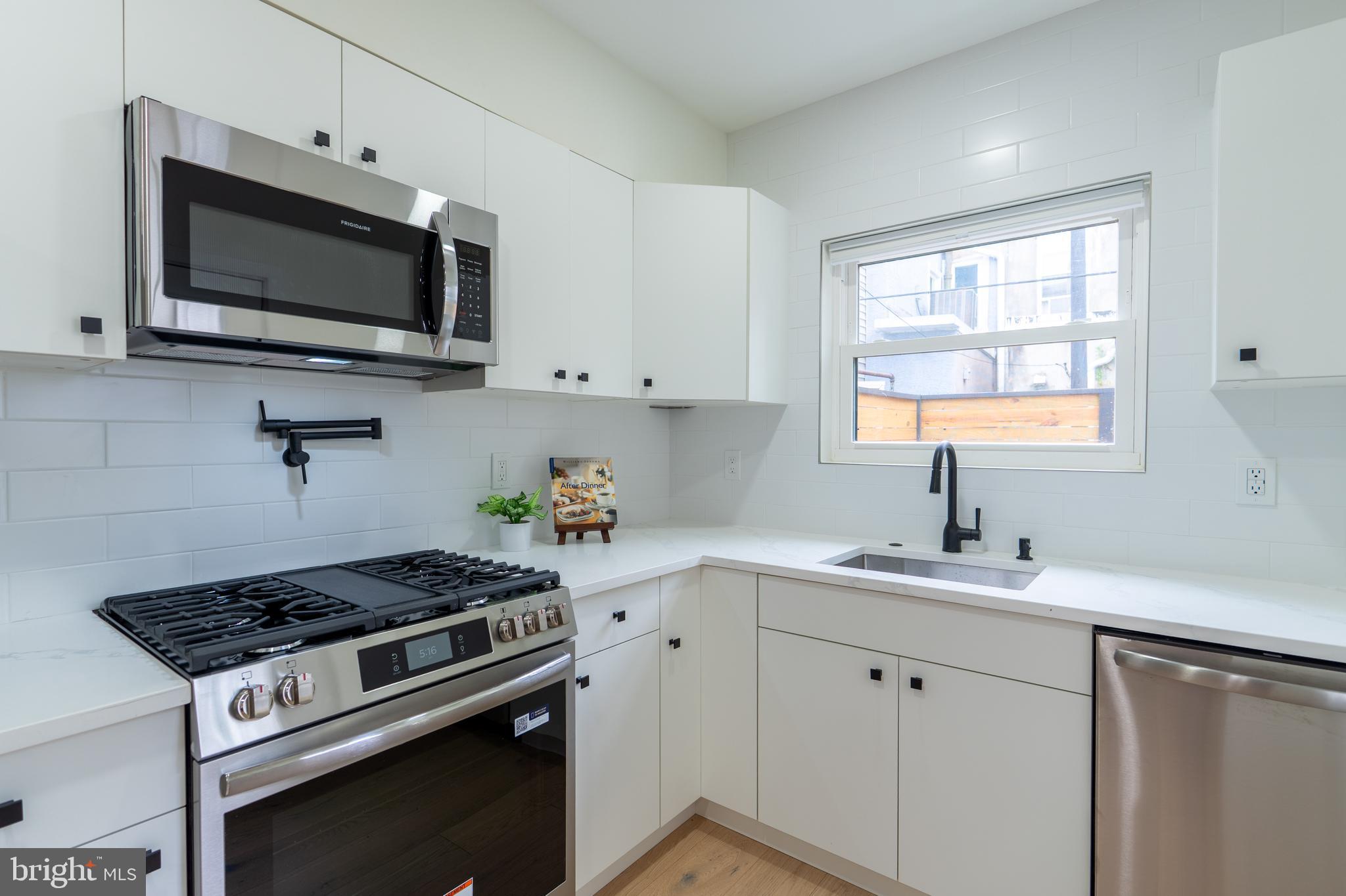 622 McClellan Street Philadelphia, PA 19148 - Photo 16 of 52 a kitchen with a sink stove and microwave