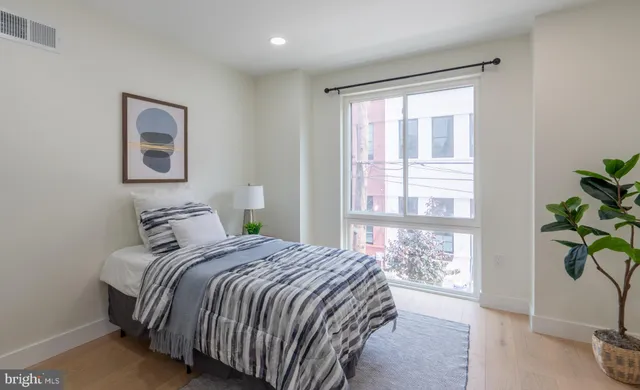 a bedroom with a bed and a window