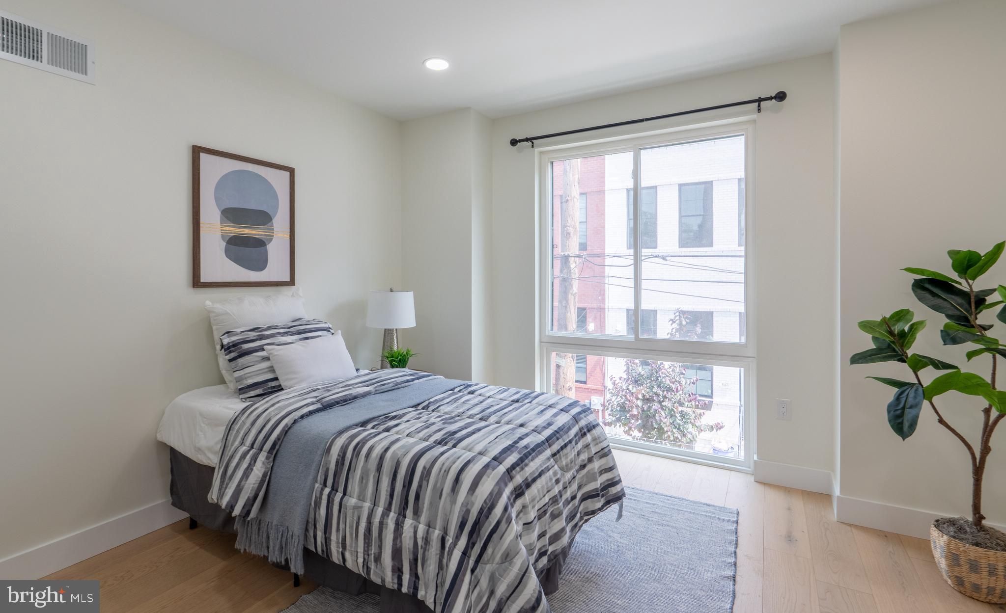 622 McClellan Street Philadelphia, PA 19148 - Photo 19 of 52 a bedroom with a bed and a window