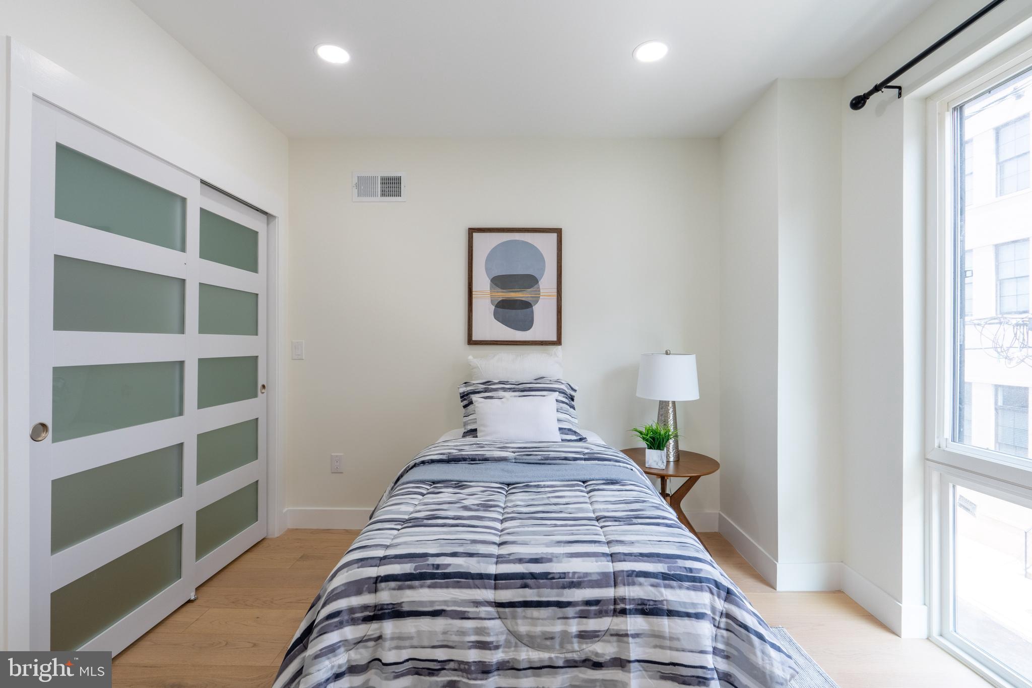 622 McClellan Street Philadelphia, PA 19148 - Photo 20 of 52 a view of a bedroom with wooden floor and a window