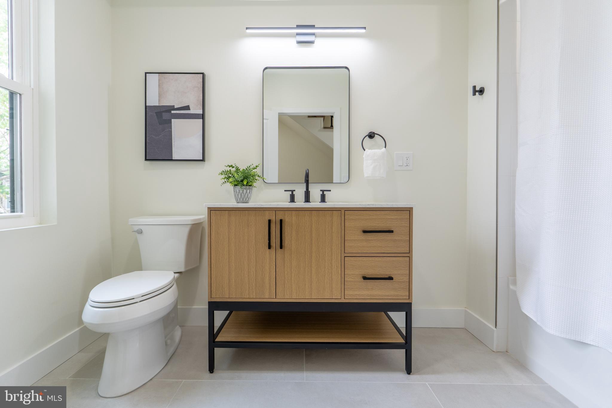 622 McClellan Street Philadelphia, PA 19148 - Photo 24 of 52 a bathroom with a toilet a sink and mirror