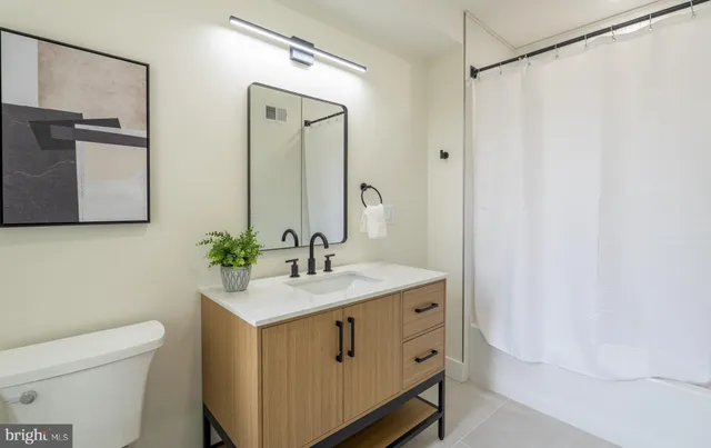 a bathroom with a sink a toilet and mirror