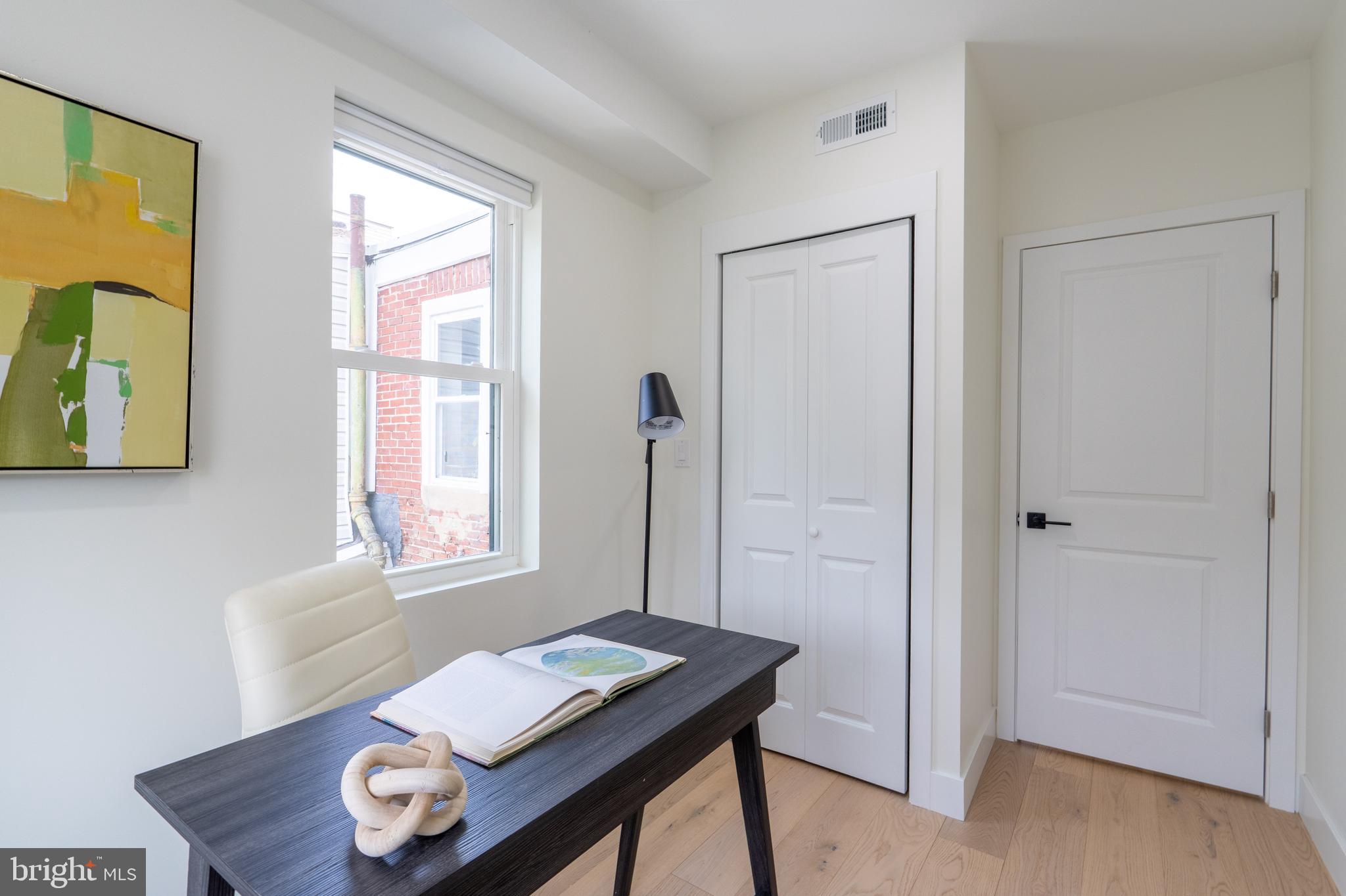 622 McClellan Street Philadelphia, PA 19148 - Photo 29 of 52 a view of a workspace with furniture and a window