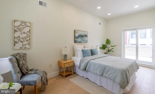 a bedroom with a bed and chair