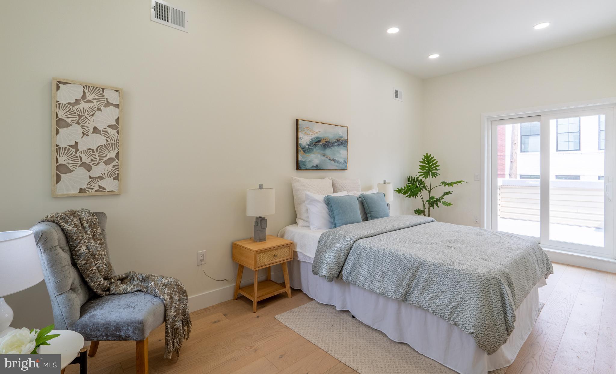 622 McClellan Street Philadelphia, PA 19148 - Photo 30 of 52 a bedroom with a bed and chair