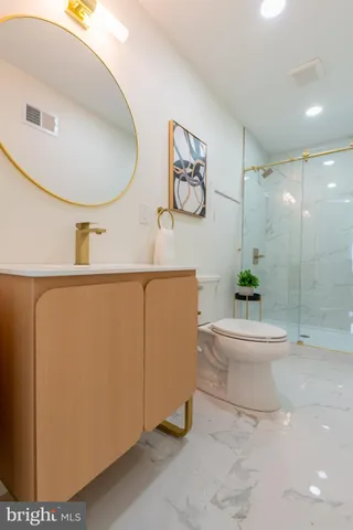 a bathroom with a sink a toilet and a mirror