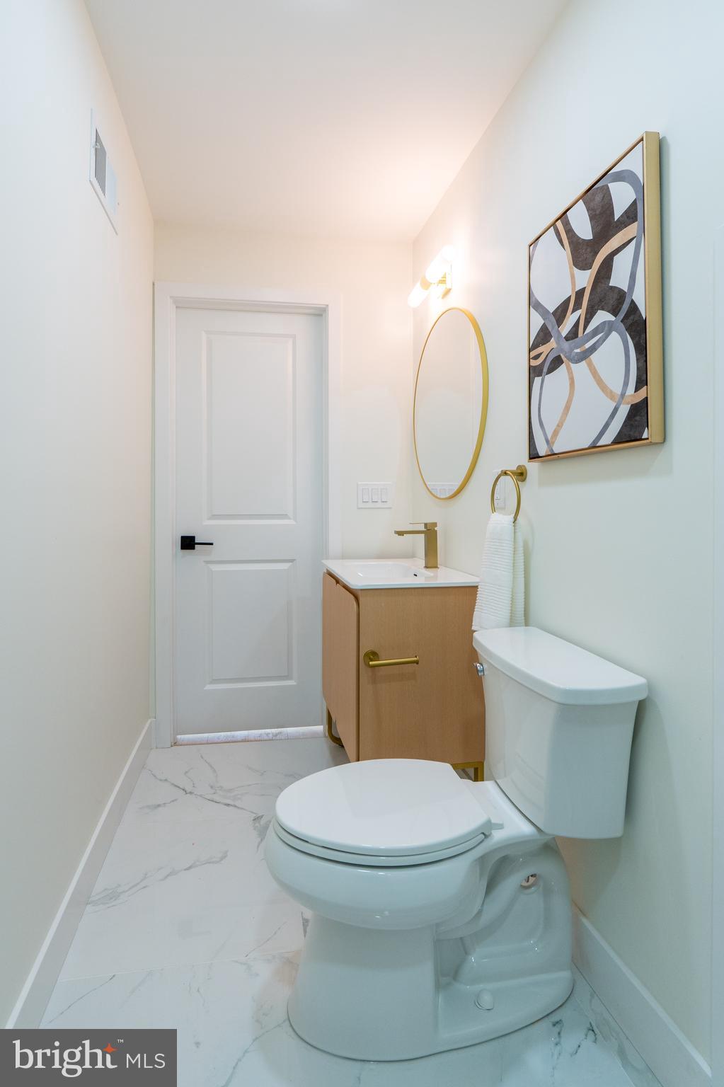 622 McClellan Street Philadelphia, PA 19148 - Photo 39 of 52 a bathroom with a toilet a sink and mirror
