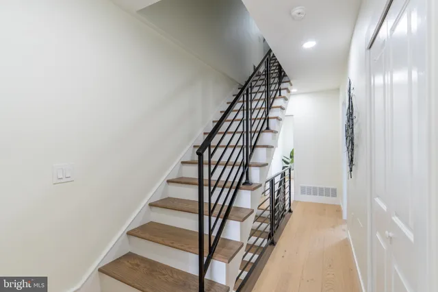 a view of entryway and hall with wooden floor