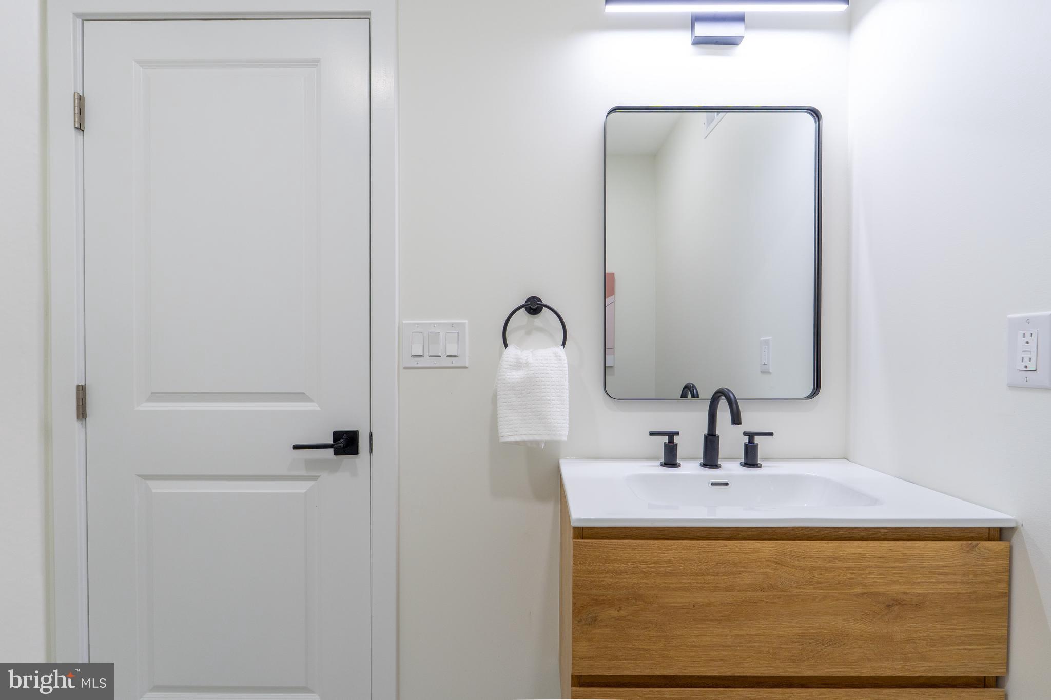 622 McClellan Street Philadelphia, PA 19148 - Photo 48 of 52 a bathroom with a sink and mirror