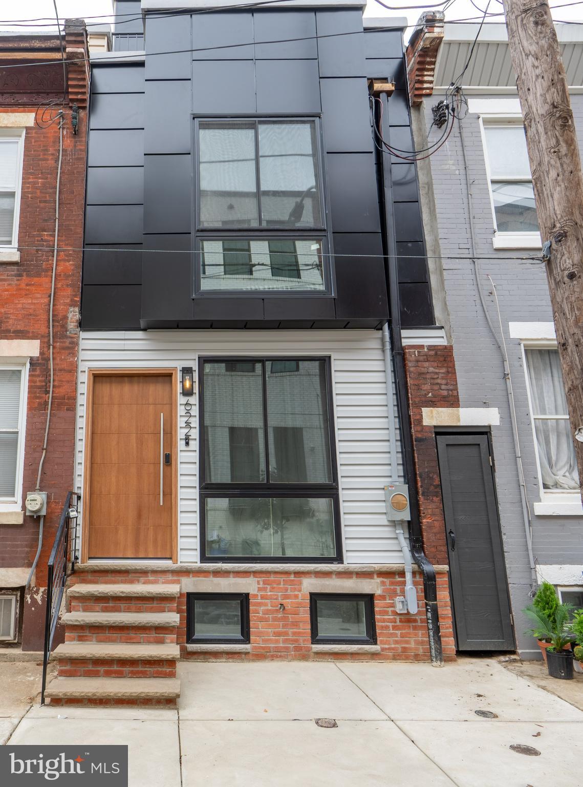 622 McClellan Street Philadelphia, PA 19148 - Photo 52 of 52 a front view of a house with a yard