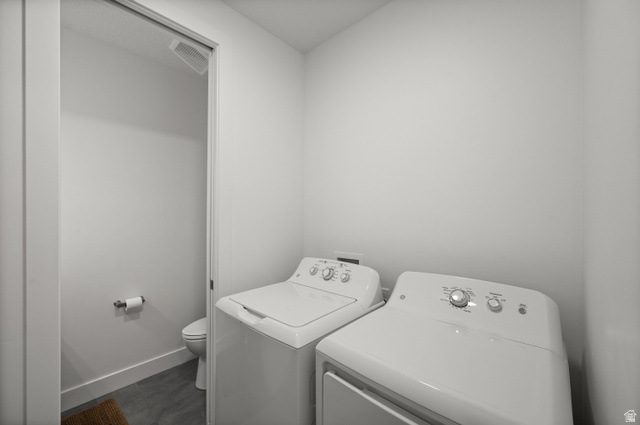 507 West Windmill Gate Cove Draper, UT 84020 - Photo 29 of 46 Laundry area with baseboards and washing machine and dryer