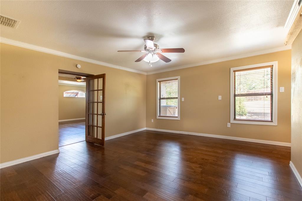 308 Sanders Road Denton, TX 76210 - Photo 22 of 31 Hardwood-style flooring throughout, crown molding, and a ceiling fan with integrated lighting