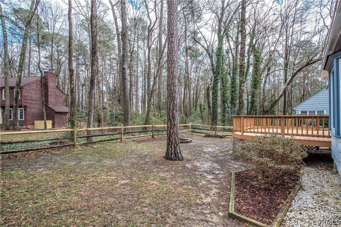3003 Sagegrove Road Midlothian, VA 23112 - Photo 3 of 22 a backyard of a house with lots of green space and trees