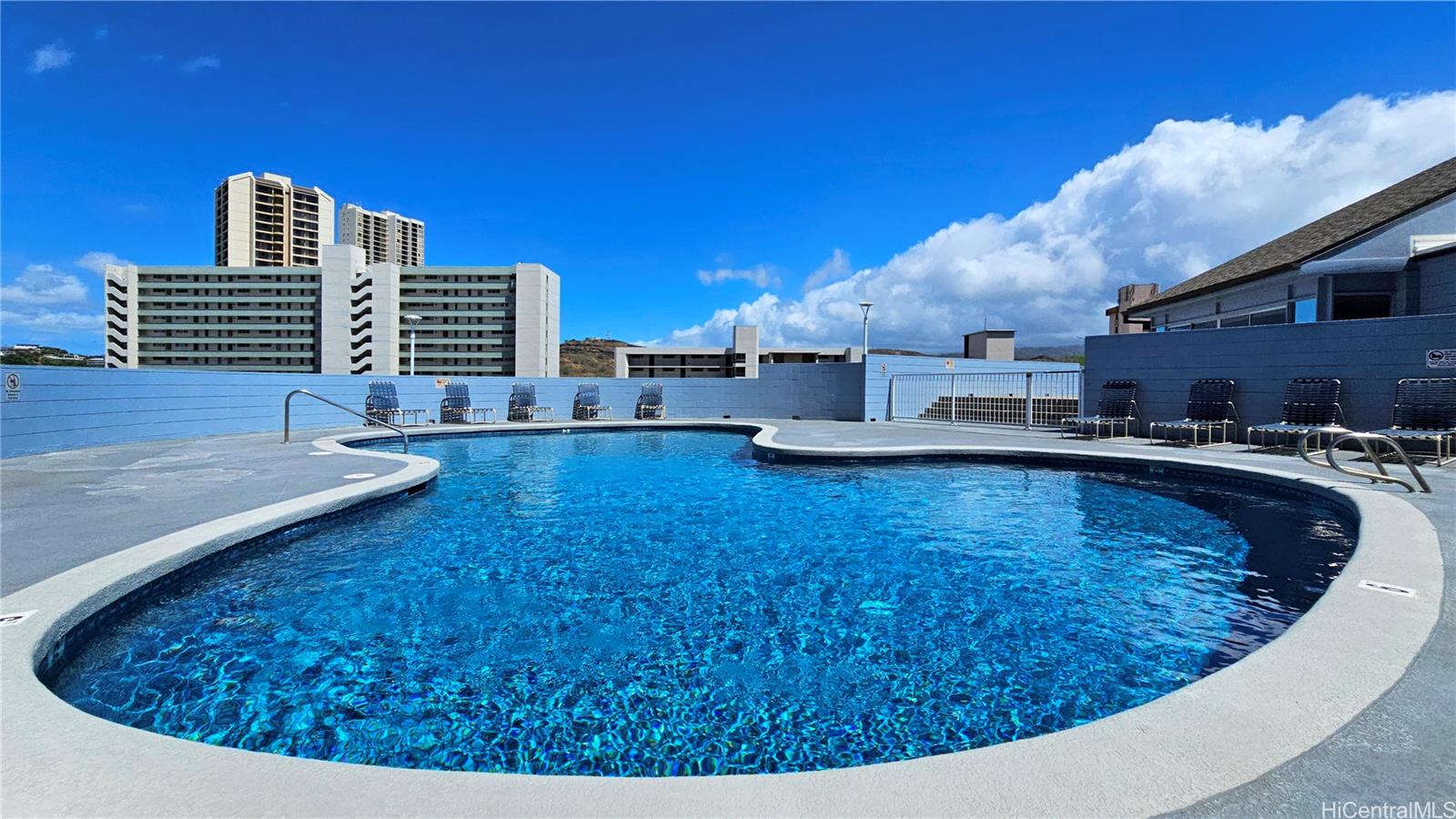 3045 Ala Napuaa Place, Unit 1613 Honolulu, HI 96818 - Photo 13 of 20 a swimming pool with outdoor seating and yard