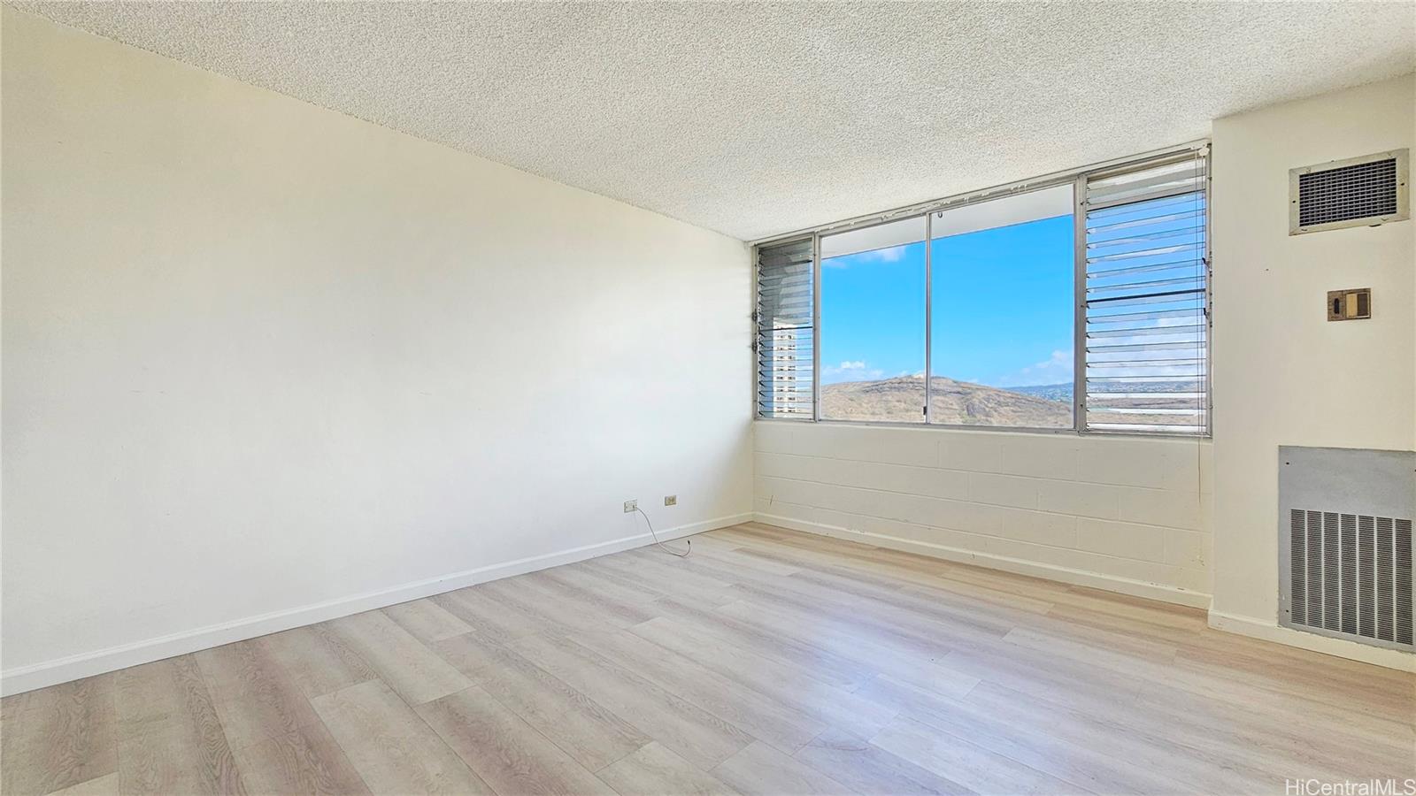 3045 Ala Napuaa Place, Unit 1613 Honolulu, HI 96818 - Photo 6 of 20 an empty room with wooden floor and windows