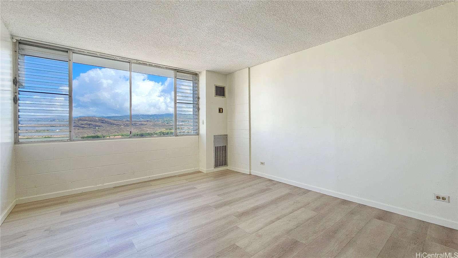 3045 Ala Napuaa Place, Unit 1613 Honolulu, HI 96818 - Photo 7 of 20 an empty room with wooden floor and windows