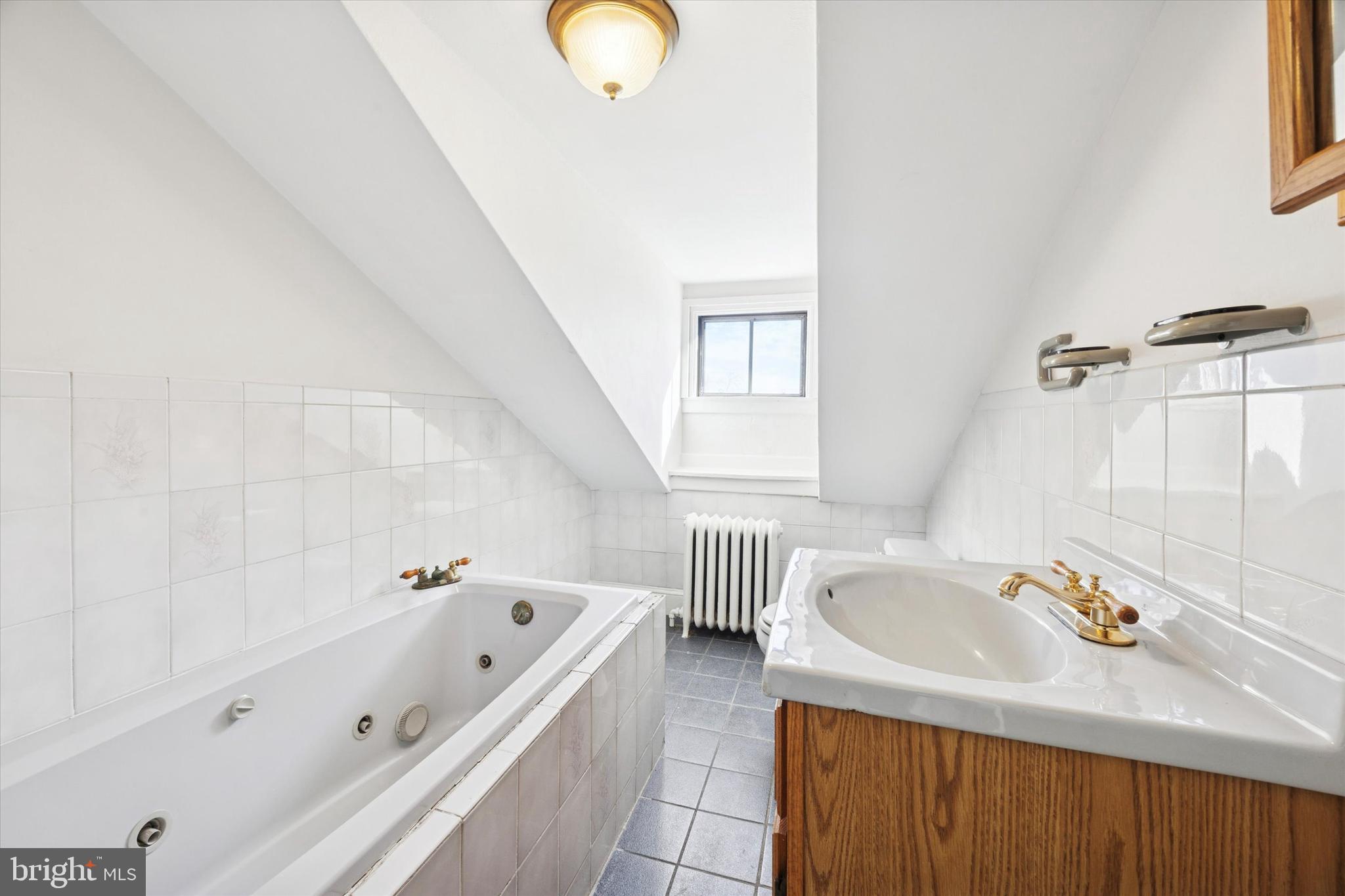 46 Copley Road Upper Darby, PA 19082 - Photo 17 of 21 a bathroom with a tub a sink and a window