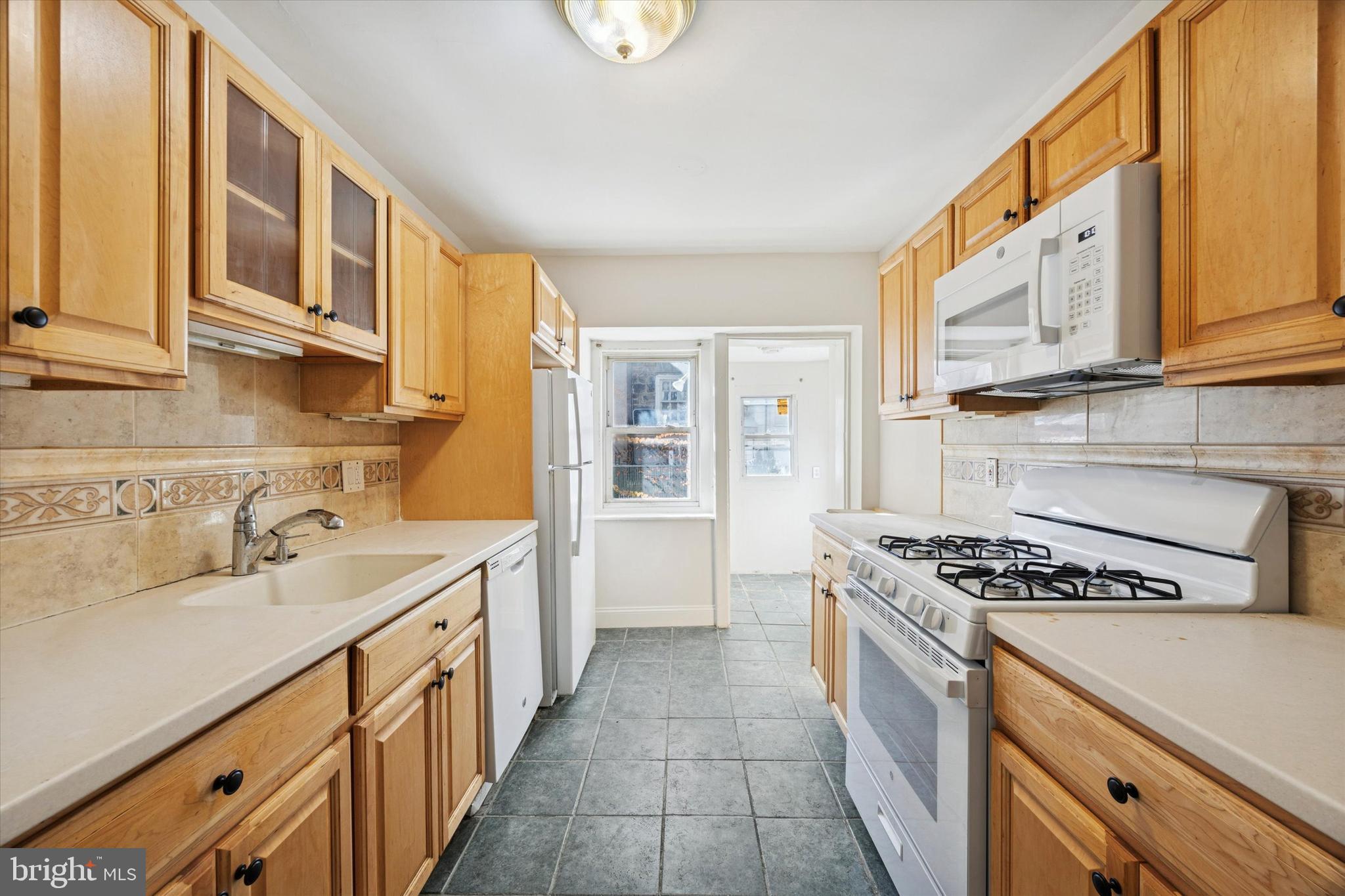 46 Copley Road Upper Darby, PA 19082 - Photo 9 of 21 a kitchen with stainless steel appliances a sink stove and cabinets